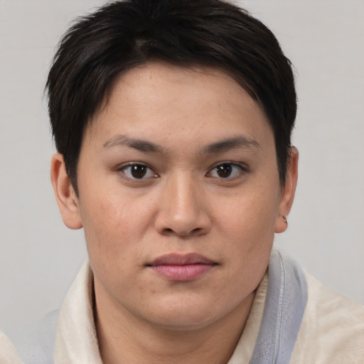 Joyful asian young-adult female with short  brown hair and brown eyes