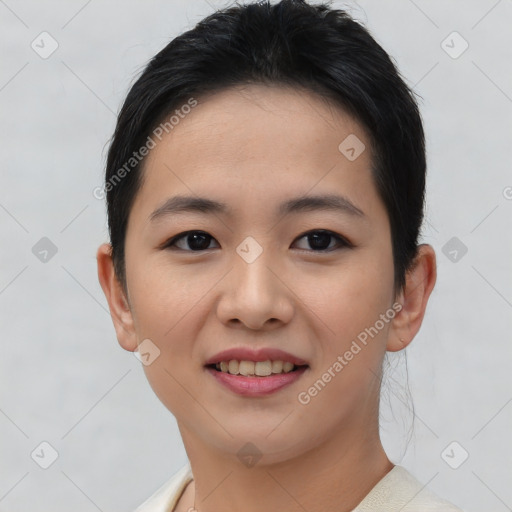 Joyful asian young-adult female with short  brown hair and brown eyes