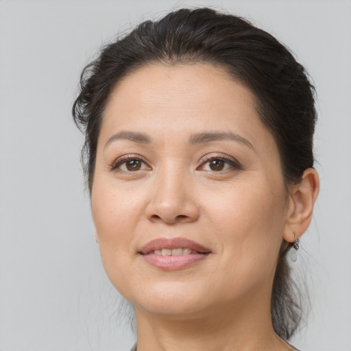 Joyful white adult female with medium  brown hair and brown eyes