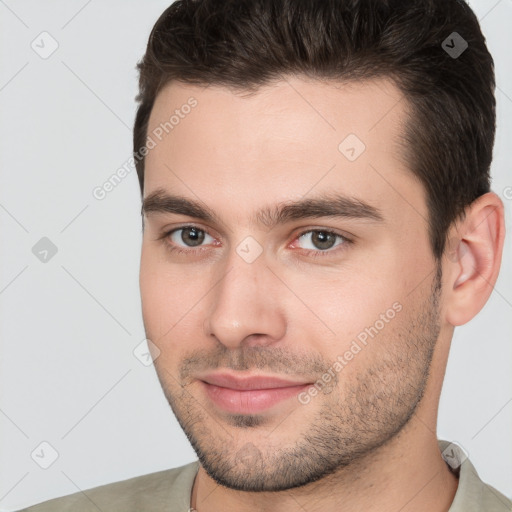 Joyful white young-adult male with short  brown hair and brown eyes