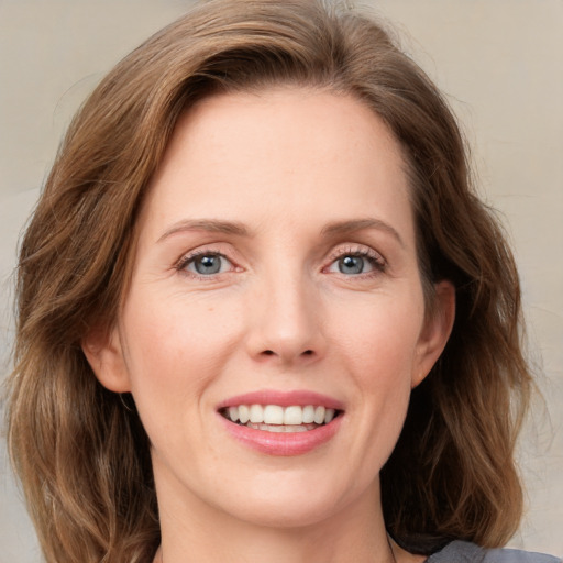 Joyful white young-adult female with medium  brown hair and blue eyes