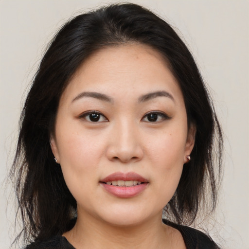 Joyful asian young-adult female with medium  brown hair and brown eyes