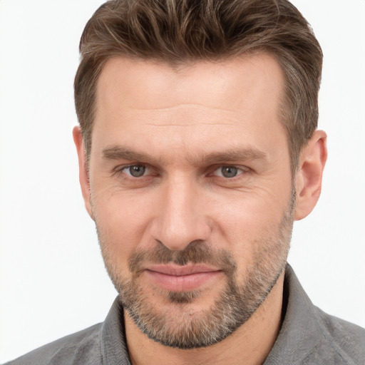 Joyful white adult male with short  brown hair and grey eyes