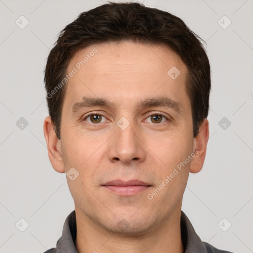 Joyful white young-adult male with short  brown hair and grey eyes