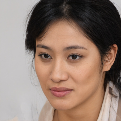 Joyful asian young-adult female with medium  brown hair and brown eyes