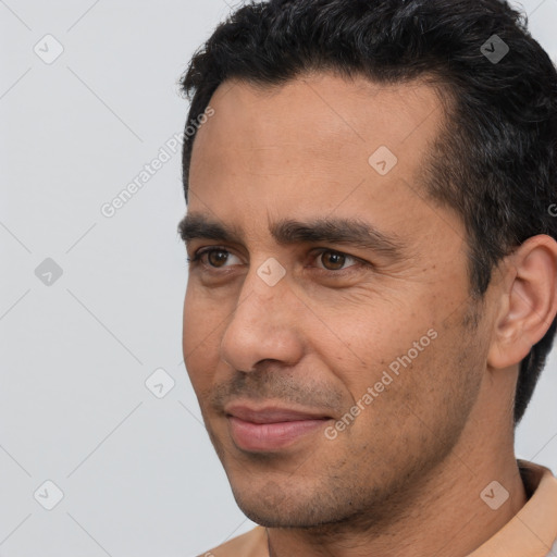 Joyful white adult male with short  black hair and brown eyes