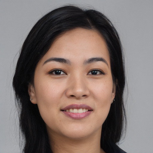 Joyful asian young-adult female with long  black hair and brown eyes
