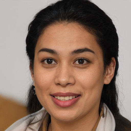Joyful latino young-adult female with medium  brown hair and brown eyes