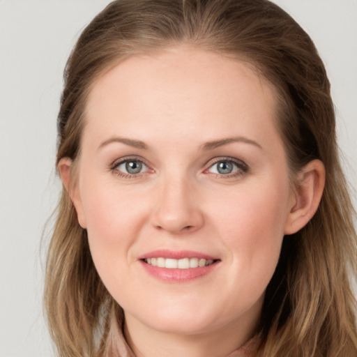 Joyful white young-adult female with long  brown hair and grey eyes