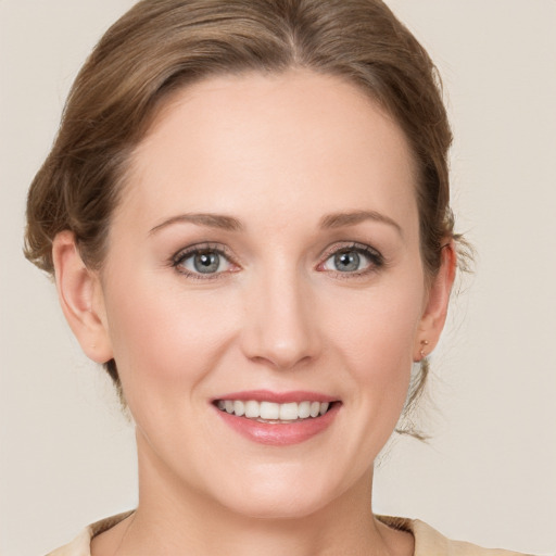 Joyful white young-adult female with medium  brown hair and green eyes