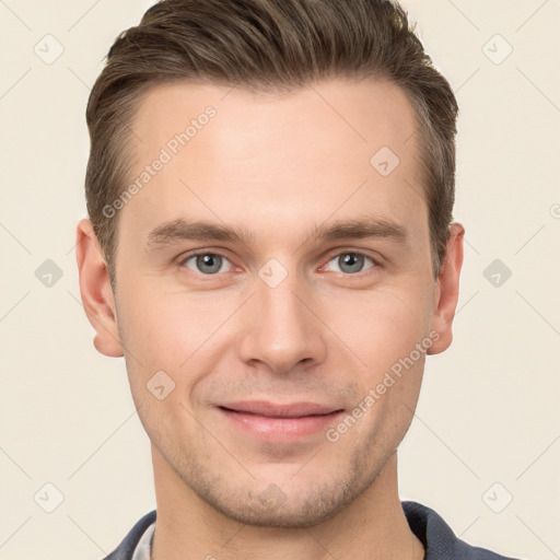 Joyful white young-adult male with short  brown hair and grey eyes