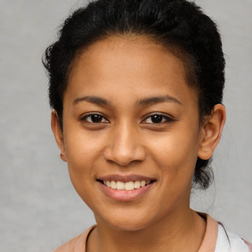 Joyful latino young-adult female with short  brown hair and brown eyes