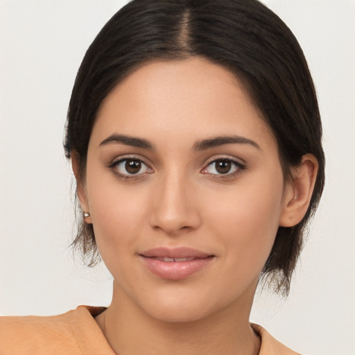 Joyful latino young-adult female with medium  brown hair and brown eyes