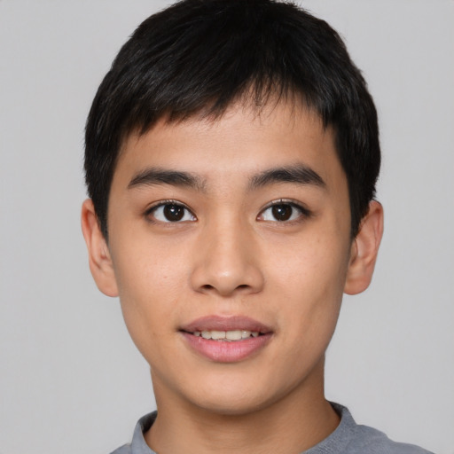 Joyful asian young-adult male with short  black hair and brown eyes