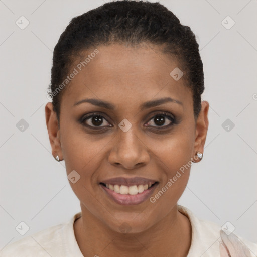 Joyful black young-adult female with short  black hair and brown eyes