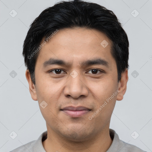 Joyful asian young-adult male with short  black hair and brown eyes