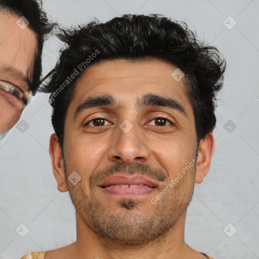 Joyful latino young-adult male with short  brown hair and brown eyes