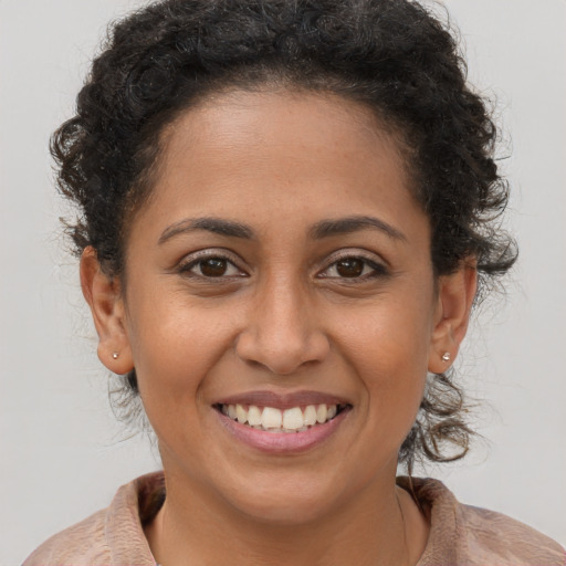 Joyful latino young-adult female with long  brown hair and brown eyes