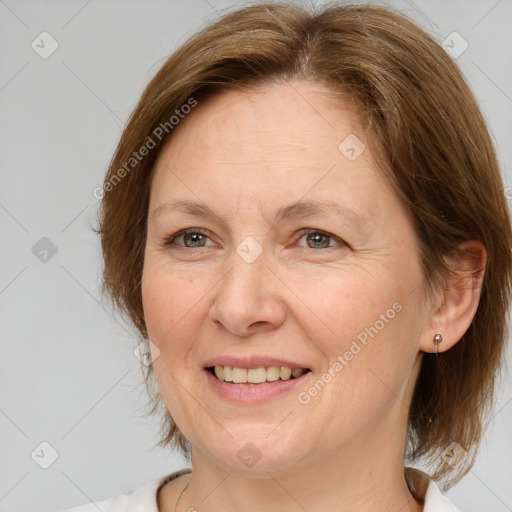 Joyful white adult female with medium  brown hair and brown eyes