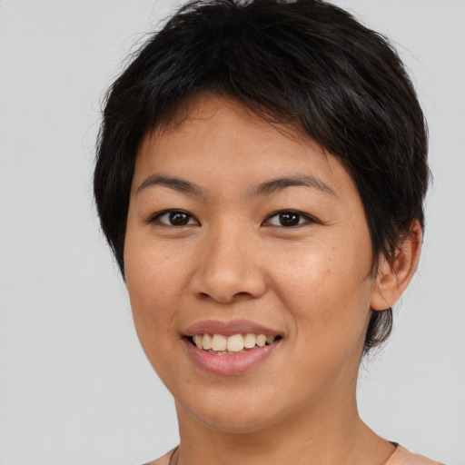 Joyful asian young-adult female with short  brown hair and brown eyes