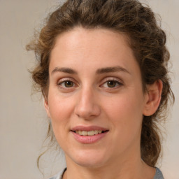 Joyful white young-adult female with medium  brown hair and green eyes