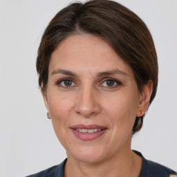 Joyful white adult female with medium  brown hair and grey eyes