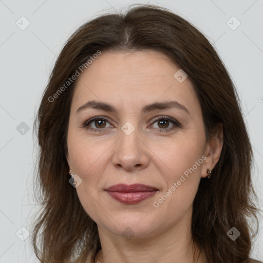 Joyful white adult female with long  brown hair and brown eyes