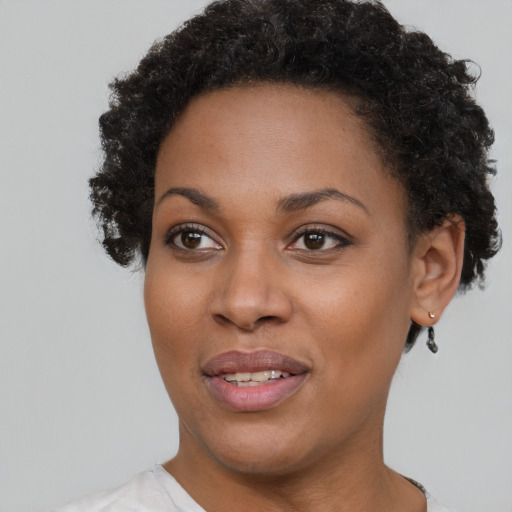 Joyful black young-adult female with short  brown hair and brown eyes