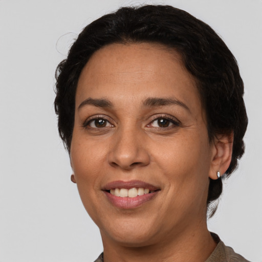 Joyful white adult female with short  black hair and brown eyes