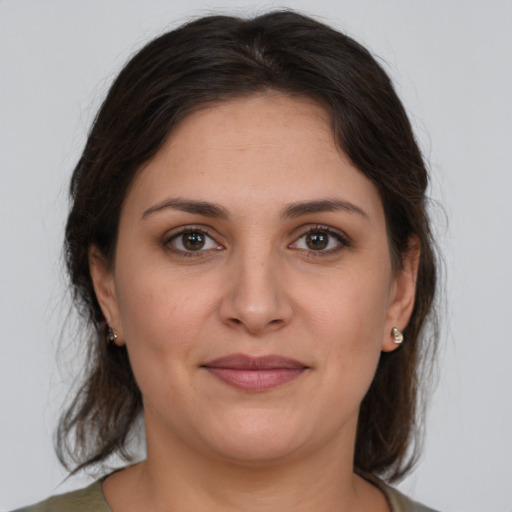 Joyful white young-adult female with medium  brown hair and brown eyes