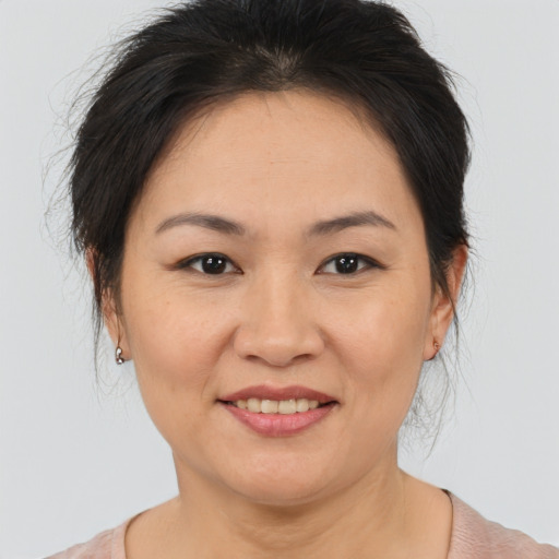Joyful asian adult female with medium  brown hair and brown eyes