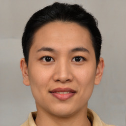 Joyful asian young-adult female with short  brown hair and brown eyes