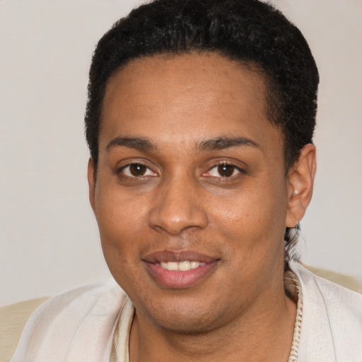 Joyful black young-adult female with short  brown hair and brown eyes
