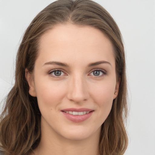 Joyful white young-adult female with long  brown hair and grey eyes