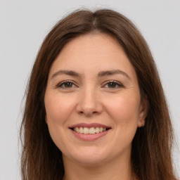 Joyful white adult female with long  brown hair and brown eyes