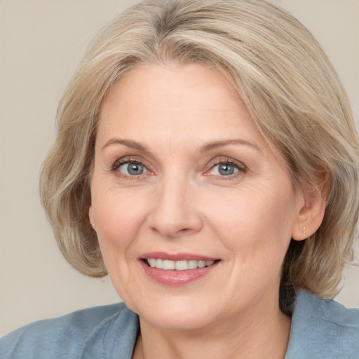 Joyful white adult female with medium  brown hair and grey eyes