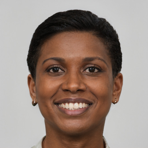 Joyful black young-adult female with short  brown hair and brown eyes