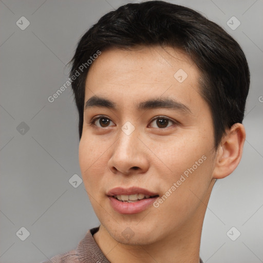 Joyful asian young-adult male with short  brown hair and brown eyes