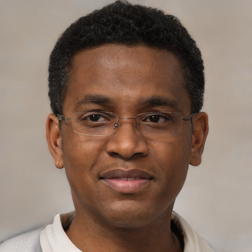 Joyful black young-adult male with short  black hair and brown eyes