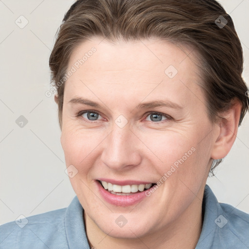 Joyful white young-adult female with short  brown hair and grey eyes