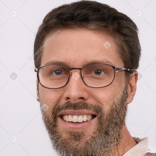 Joyful white adult male with short  brown hair and brown eyes