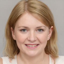 Joyful white young-adult female with medium  brown hair and blue eyes