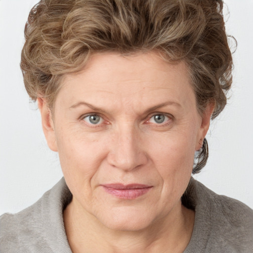 Joyful white adult female with medium  brown hair and grey eyes