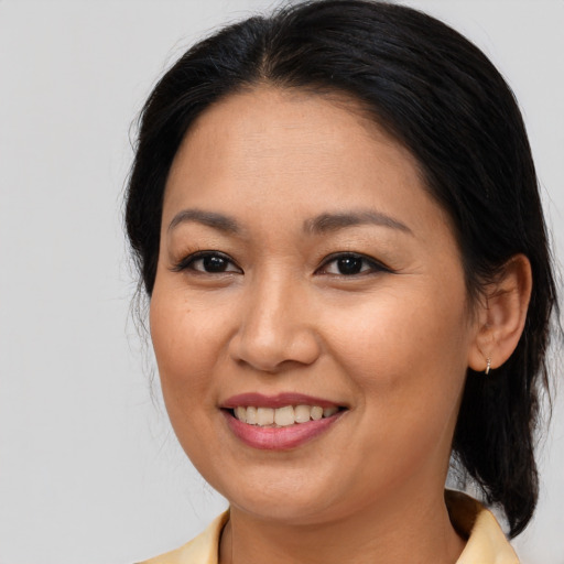 Joyful asian young-adult female with medium  brown hair and brown eyes