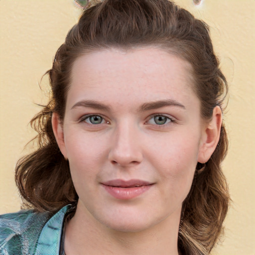 Joyful white young-adult female with long  brown hair and blue eyes