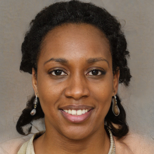 Joyful black young-adult female with medium  brown hair and brown eyes