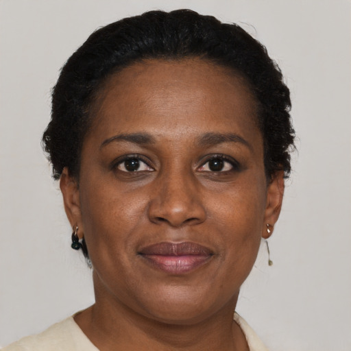 Joyful black adult female with short  brown hair and brown eyes