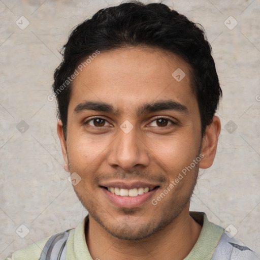 Joyful white young-adult male with short  black hair and brown eyes