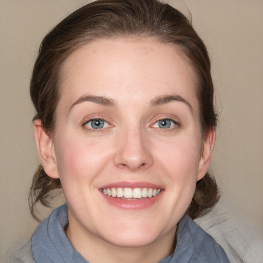 Joyful white young-adult female with medium  brown hair and blue eyes