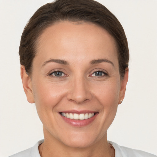 Joyful white adult female with short  brown hair and brown eyes